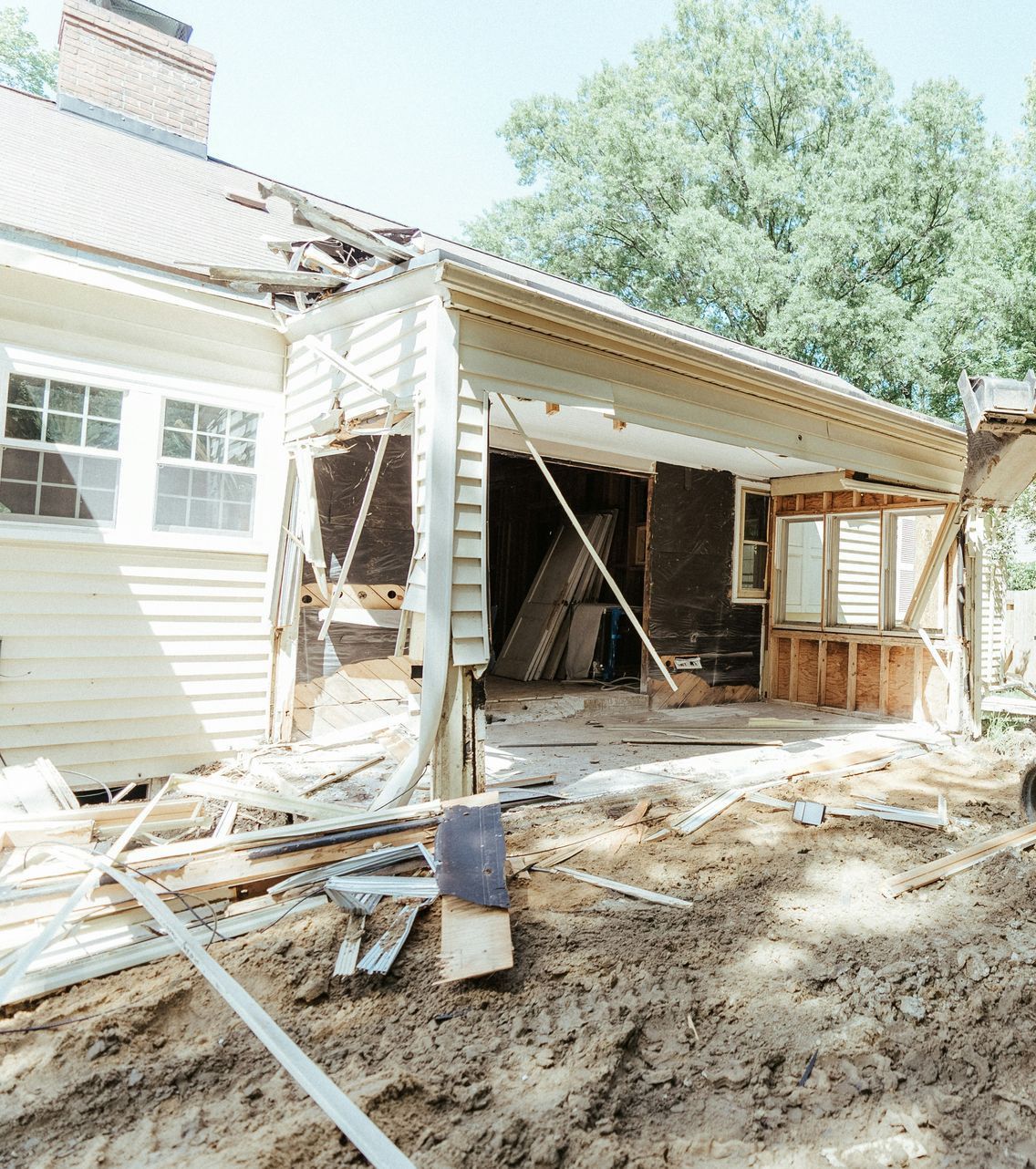 a bulldozer is parked in front of a house